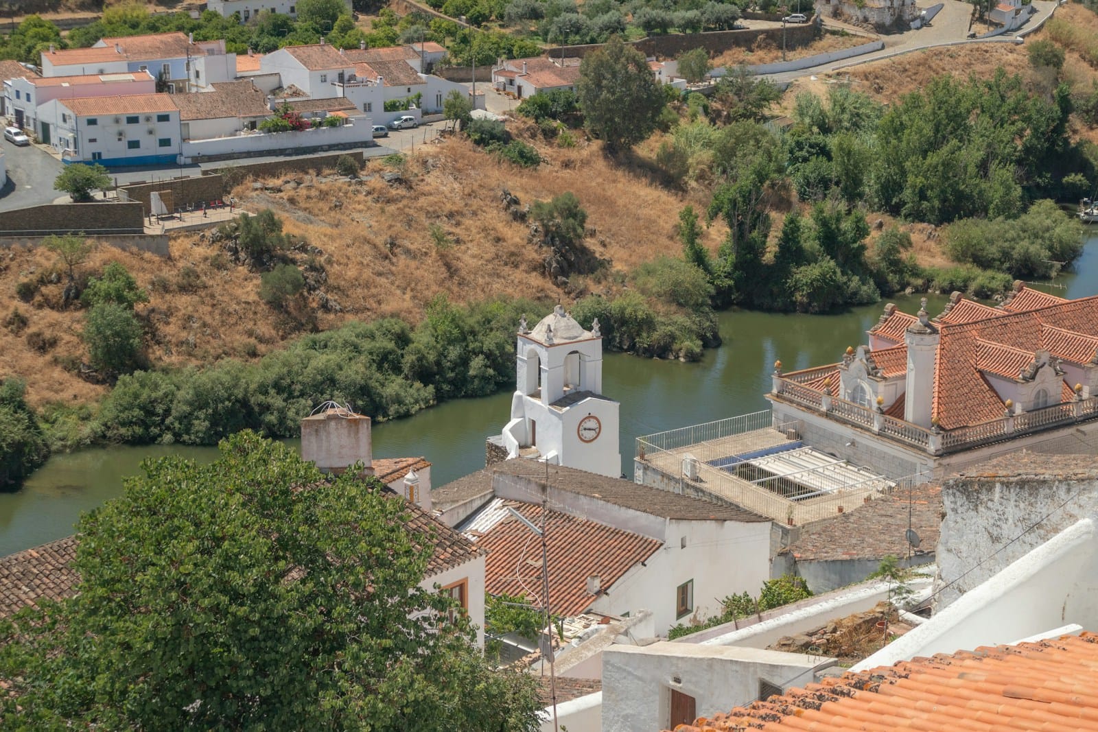 A whitewashed village above a river at the end of a riding stage